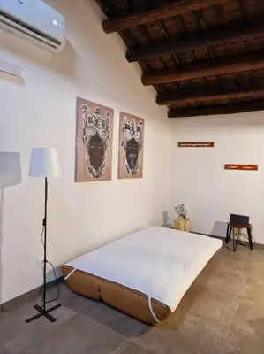 a bedroom with a large bed and two pictures on the wall at Tuttoporto-Apartments LEVANTE in Palermo