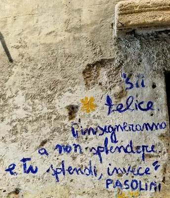 a wall with blue writing on the side of it at Tuttoporto-Apartments LEVANTE in Palermo