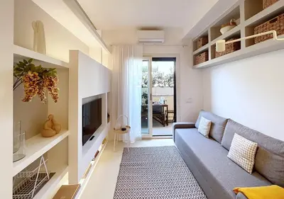 a living room with a couch and a television at Solemar Sicilia - White Loft in Palermo