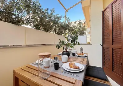 a wooden table with plates of food on it at Solemar Sicilia - White Loft in Palermo