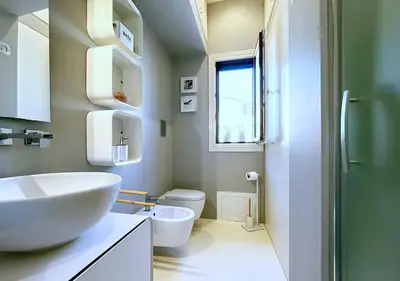 a white bathroom with a sink and a toilet at Solemar Sicilia - White Loft in Palermo