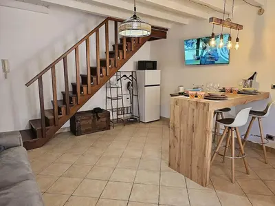 a kitchen with a table and a kitchen with a staircase at VeraHouse in Palermo