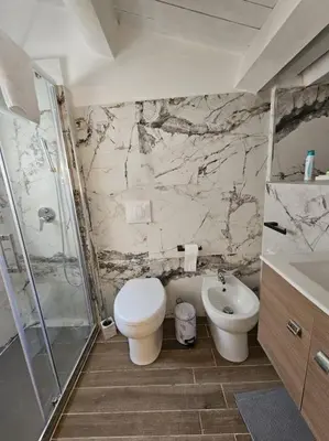 a bathroom with a toilet and a shower and a sink at VeraHouse in Palermo
