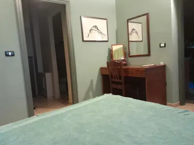 a bedroom with a desk with a computer and a bed at Casa Castelli Appartamento vacanza in Bagheria