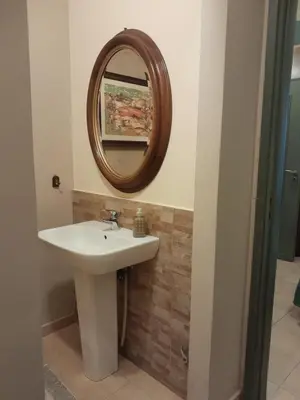 a bathroom with a sink and a mirror on the wall at Casa Castelli Appartamento vacanza in Bagheria