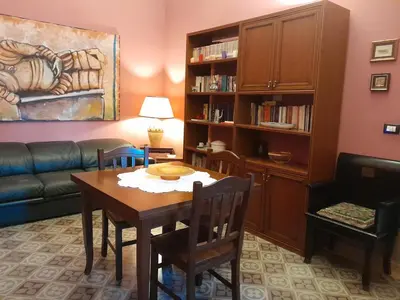 a living room with a table and a couch at Casa Castelli Appartamento vacanza in Bagheria