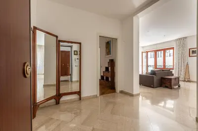 a living room with a couch and a mirror at La Cassatella family home in Palermo