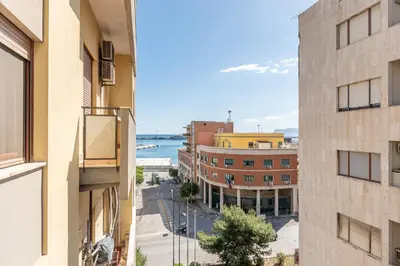 a view of a city street from a building at La Cassatella family home in Palermo