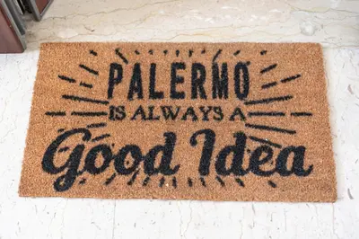 a rug that says palermo is always a good idea at La Cassatella family home in Palermo