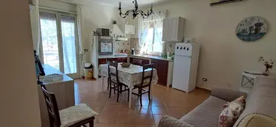 a kitchen and living room with a couch and a table at Casetta Sferracavallo in Palermo