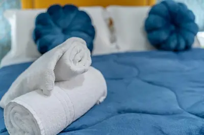 a rolled up towel sitting on top of a bed at la porta di Alba in Palermo