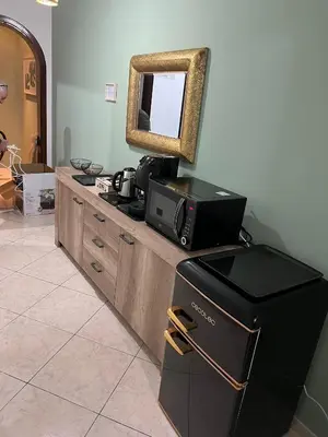 a vanity with a mirror and a television on it at la porta di Alba in Palermo