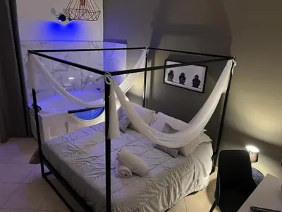 a bedroom with a canopy bed with a hammock at la porta di Alba in Palermo
