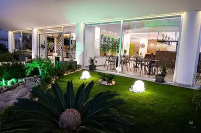a house with a garden with lights in the yard at New River Hotel in Borgetto