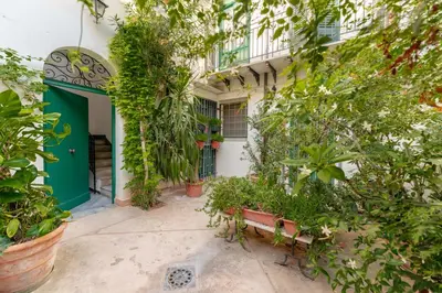 an entrance to a building with a green door and plants at Regina Suite in Palermo
