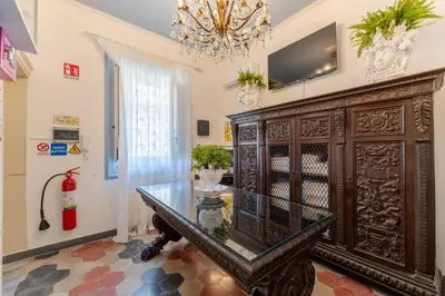 a dining room with a table and a large wooden cabinet at Regina Suite in Palermo