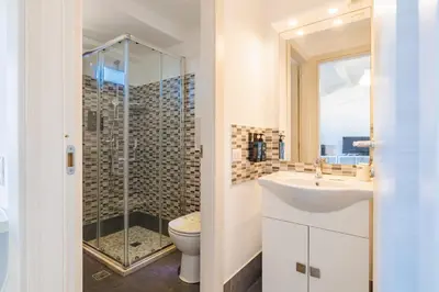 a bathroom with a toilet and a sink and a shower at Marina di Petrolo Apartments in Castellammare del Golfo