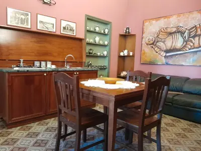 a dining room with a table and a sink at Casa Castelli Holiday Apartment in Bagheria