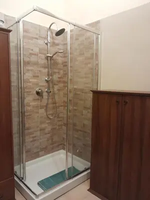 a shower with a glass enclosure in a bathroom at Casa Castelli Holiday Apartment in Bagheria