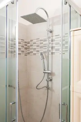 a shower with a glass door in a bathroom at Casa Marina in Palermo