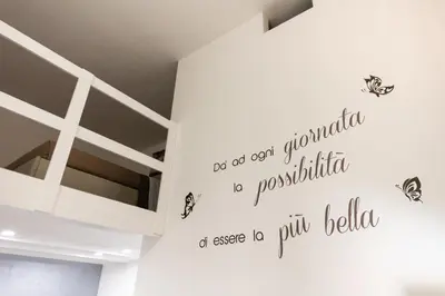 a room with a white wall with some butterflies on it at Casa Mauro in Palermo