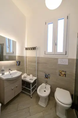 a bathroom with a toilet and a bidet and a sink at Le terrazze di Giulia in Palermo