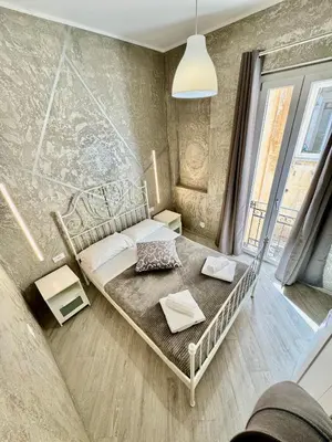 a small bedroom with a bed in a room at Le terrazze di Giulia in Palermo
