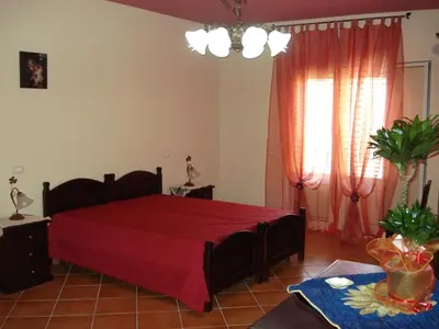 a bedroom with a red bed in a room at B&B Ulivo in Trabia