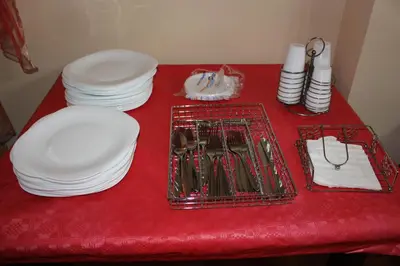 a red table with plates and dishes on it at B&B Ulivo in Trabia