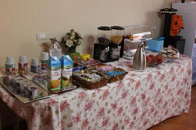a table with food and drinks on top of it at B&B Ulivo in Trabia