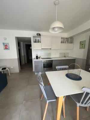 a kitchen and dining room with a table and chairs at Caladdaura in Palermo