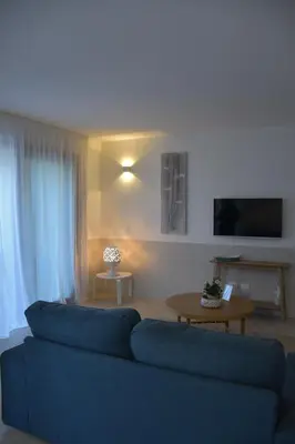 a living room with a blue couch and a table at Caladdaura in Palermo
