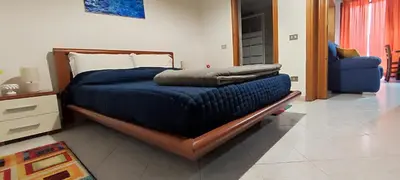 a bedroom with a bed with a blue comforter at Abba Palermo centro in Palermo