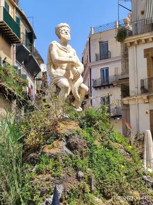 a statue of a man sitting on top of a hill at Abba Palermo centro in Palermo