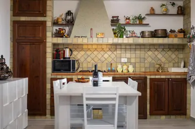 a kitchen with a white island in the middle at Villa Mare E Monti in Castellammare del Golfo