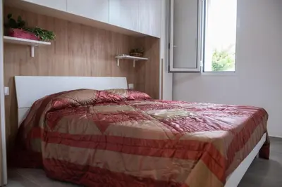a bedroom with a bed in a room with a window at Villa Mare E Monti in Castellammare del Golfo