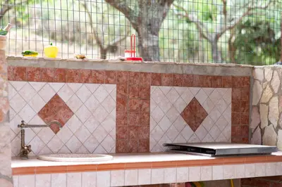 a stone counter with a sink and a window at Villa Mare E Monti in Castellammare del Golfo