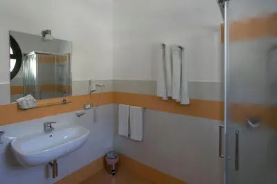 a bathroom with a sink and a shower at Rotte e Sentieri B&B in Castelluzzo