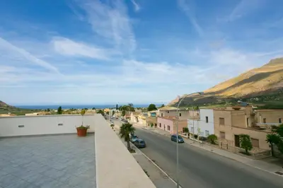 a view of a city street with buildings and mountains at Rotte e Sentieri B&B in Castelluzzo