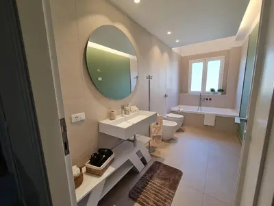 a bathroom with a sink and a mirror and a toilet at Casa Zolì - Luxury House - 210mq in Palermo