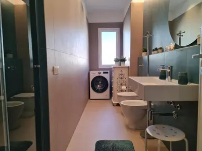 a bathroom with two toilets and a sink and a washing machine at Casa Zolì - Luxury House - 210mq in Palermo