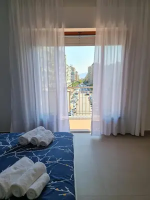 two towels on a bed in a room with a window at Casa Zolì - Luxury House - 210mq in Palermo