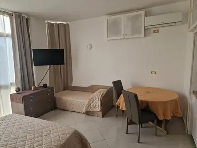 a bedroom with a table and a bed and a room with a bed at Sara House Palermo in Palermo