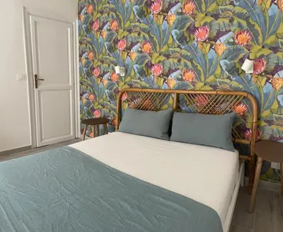 a bedroom with a bed with a floral wallpaper at Monkey house Appartamento in centro storico in Palermo