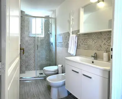 a bathroom with a toilet and a sink and a shower at Monkey house Appartamento in centro storico in Palermo
