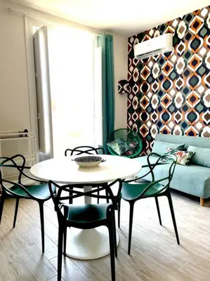 a living room with a table and chairs and a couch at Monkey house Appartamento in centro storico in Palermo