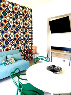a living room with a couch and a table and a tv at Monkey house Appartamento in centro storico in Palermo