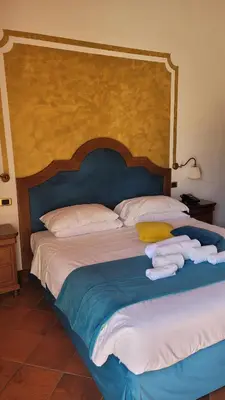 a bedroom with a large bed with towels on it at Villa Lampedusa in Palermo