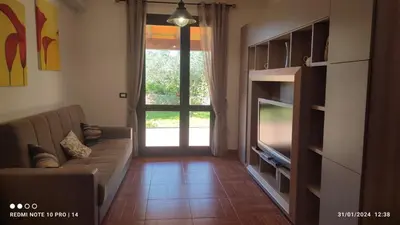 a living room with a couch and a television at ViViHolidays in Castellammare del Golfo