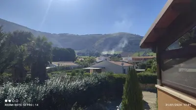 a view of a house with mountains in the background at ViViHolidays in Castellammare del Golfo